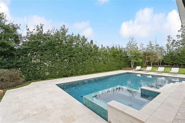 outdoor pool featuring a patio area and a hot tub