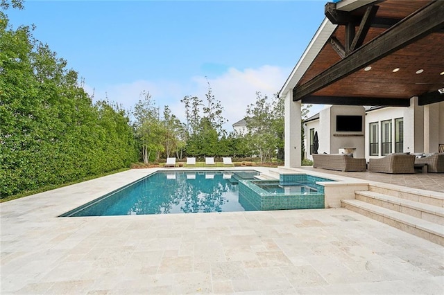 view of pool with a patio area, a pool with connected hot tub, and an outdoor hangout area