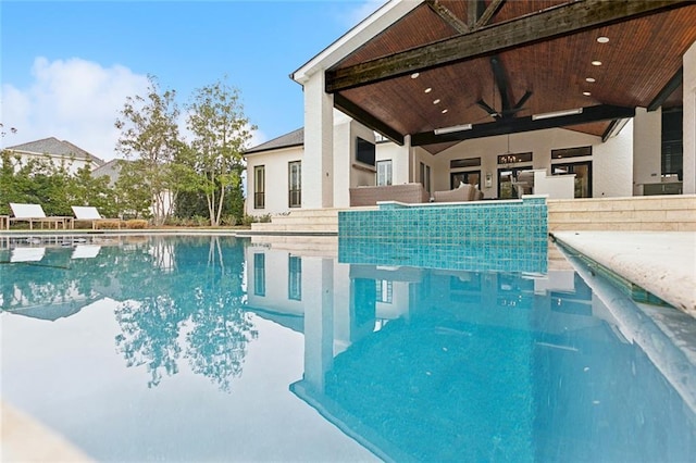 view of swimming pool featuring a ceiling fan