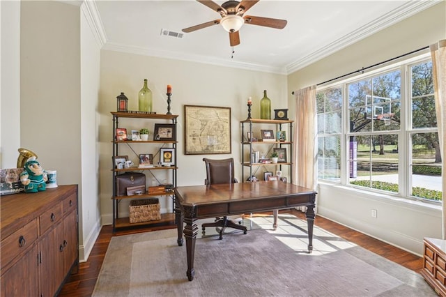 office area featuring a ceiling fan, baseboards, visible vents, dark wood finished floors, and ornamental molding