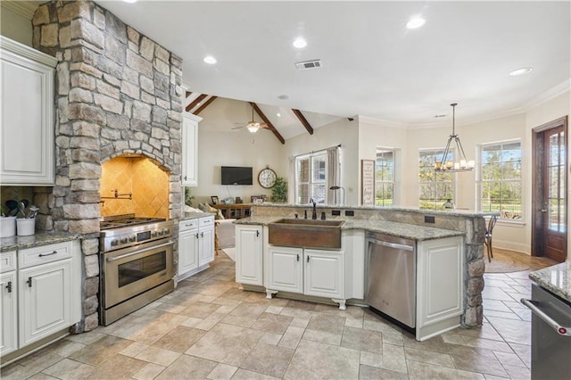 kitchen featuring light stone countertops, visible vents, a sink, stainless steel appliances, and white cabinets