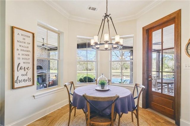 dining room featuring visible vents, baseboards, a healthy amount of sunlight, and ornamental molding