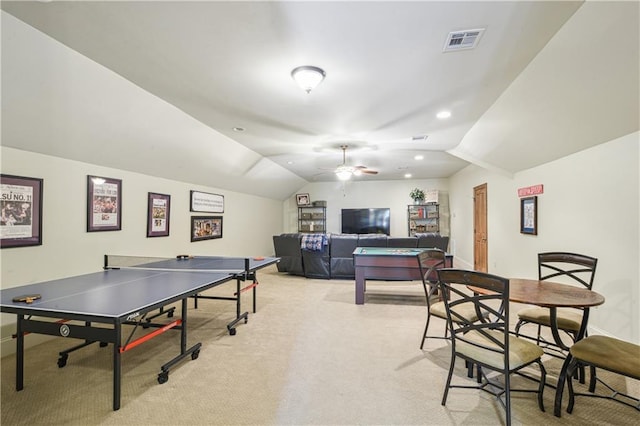 recreation room with visible vents, light colored carpet, baseboards, and lofted ceiling