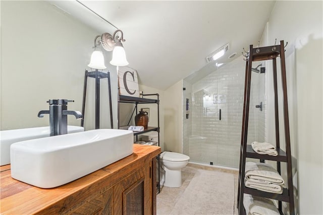 full bath with tile patterned floors, toilet, a stall shower, vanity, and vaulted ceiling