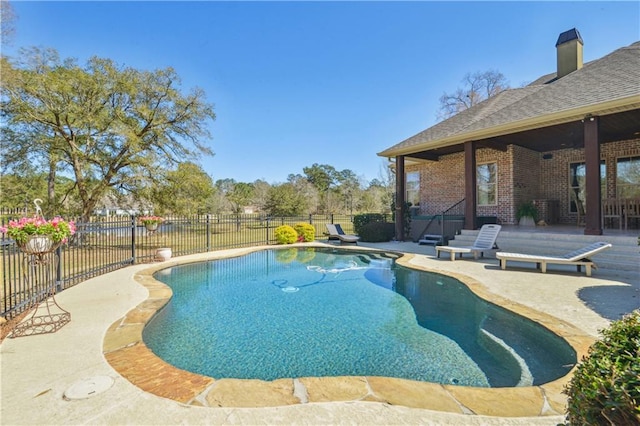 view of swimming pool with a patio area, a fenced in pool, and fence