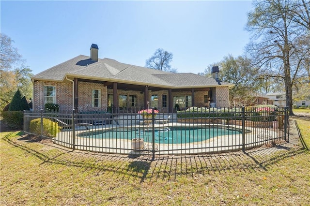 view of swimming pool with fence, a lawn, and a patio area