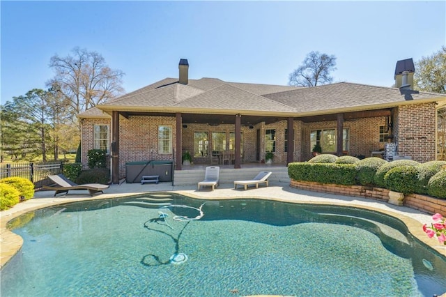 view of pool featuring a fenced in pool, a hot tub, fence, a patio area, and a diving board