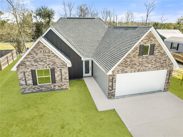 view of front of house featuring a front yard, concrete driveway, and a garage