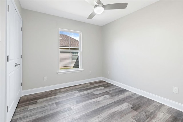 unfurnished room featuring ceiling fan, baseboards, and wood finished floors