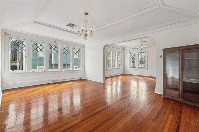 unfurnished room with arched walkways, visible vents, crown molding, and an inviting chandelier