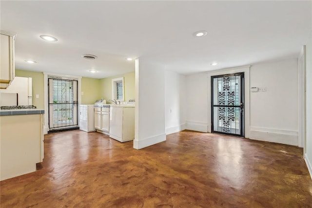 interior space featuring visible vents, recessed lighting, concrete flooring, and baseboards