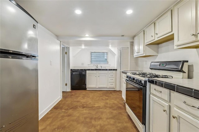 kitchen featuring black dishwasher, range with gas stovetop, recessed lighting, freestanding refrigerator, and a sink