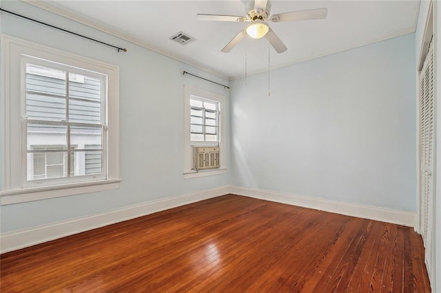 unfurnished room with visible vents, baseboards, dark wood finished floors, and a ceiling fan