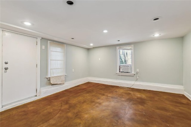 empty room featuring recessed lighting, concrete flooring, and baseboards