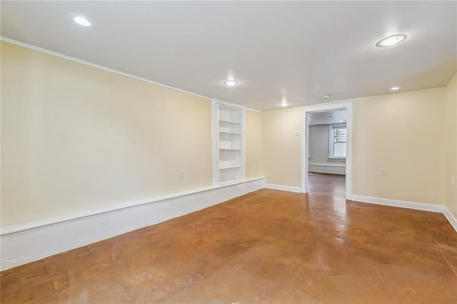 empty room with finished concrete floors, recessed lighting, baseboards, and built in features