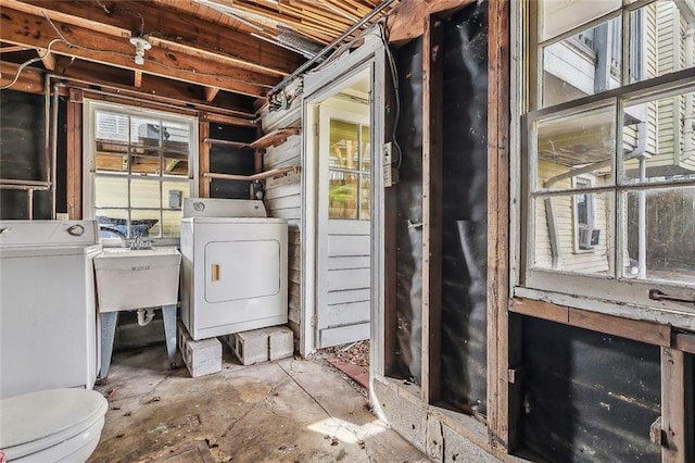 laundry room featuring a sink, separate washer and dryer, and laundry area