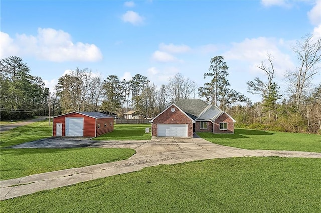 view of front of property with brick siding, a front lawn, concrete driveway, a garage, and an outdoor structure