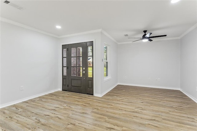 entryway featuring visible vents, a ceiling fan, wood finished floors, crown molding, and baseboards