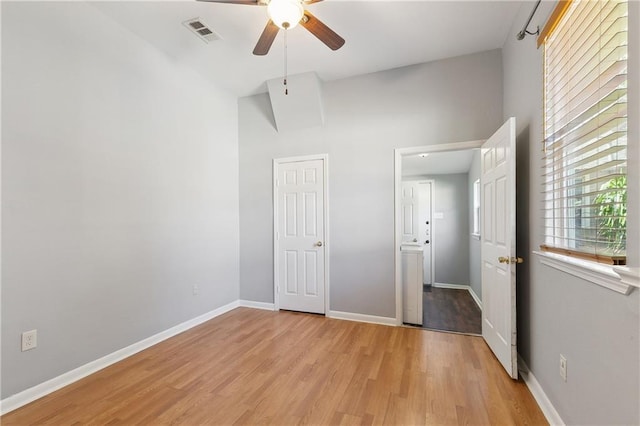 unfurnished bedroom with light wood-style flooring, baseboards, and ceiling fan