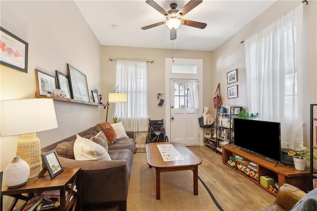 living area featuring light wood finished floors and a ceiling fan