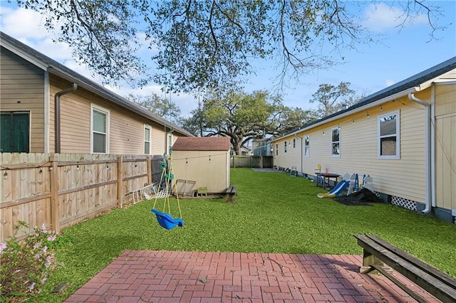 view of yard with a storage unit, a patio area, and an outbuilding