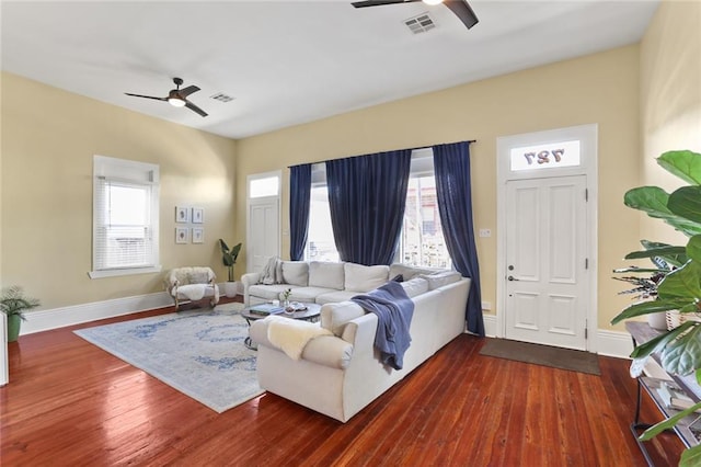 living area featuring plenty of natural light, wood finished floors, and ceiling fan