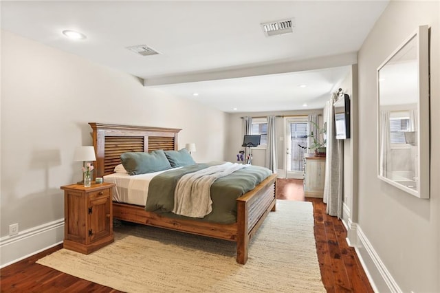 bedroom with visible vents, dark wood-type flooring, and baseboards