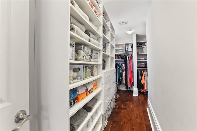 spacious closet with dark wood-type flooring and visible vents