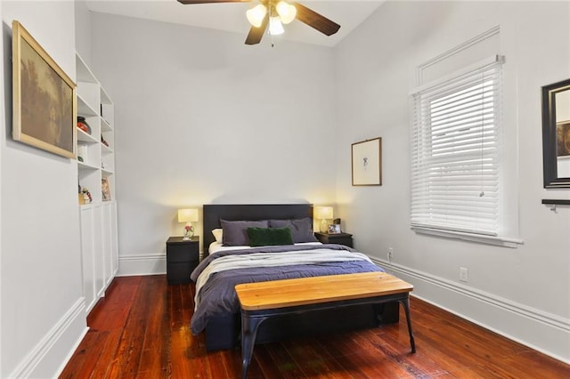 bedroom featuring a ceiling fan, baseboards, and hardwood / wood-style floors