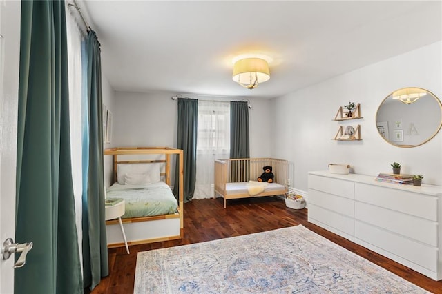 bedroom featuring wood finished floors and baseboards