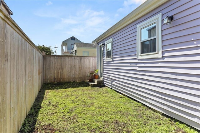 view of yard with a fenced backyard