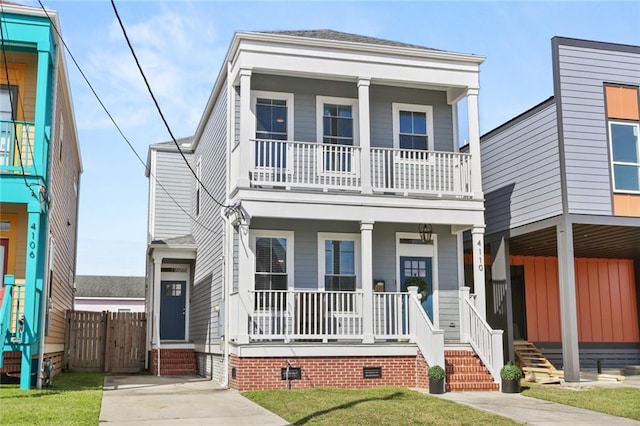 view of front of home with a porch, a front lawn, and crawl space