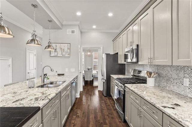 kitchen with visible vents, dark wood-type flooring, ornamental molding, appliances with stainless steel finishes, and a sink