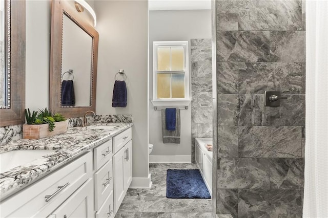 full bathroom featuring a sink, toilet, double vanity, and a tile shower