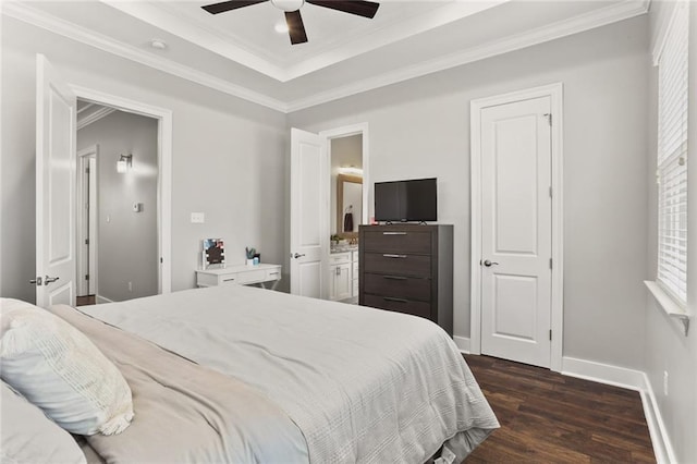 bedroom with ceiling fan, baseboards, dark wood finished floors, ornamental molding, and a raised ceiling