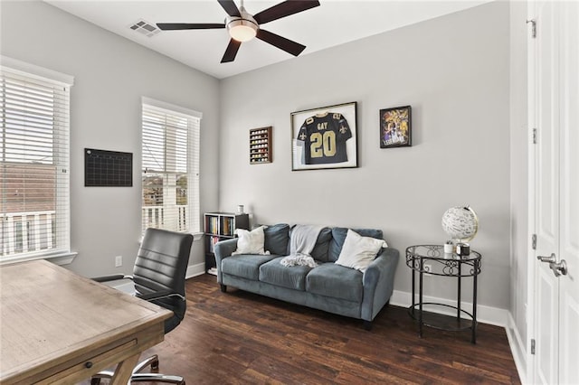 office space with visible vents, baseboards, wood finished floors, and a ceiling fan