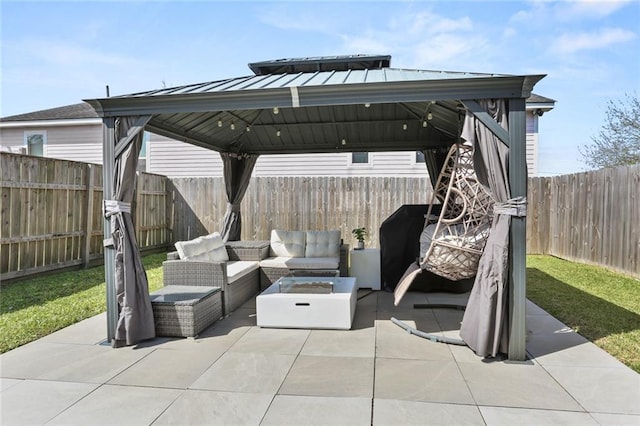 view of patio / terrace with outdoor lounge area, a gazebo, and a fenced backyard