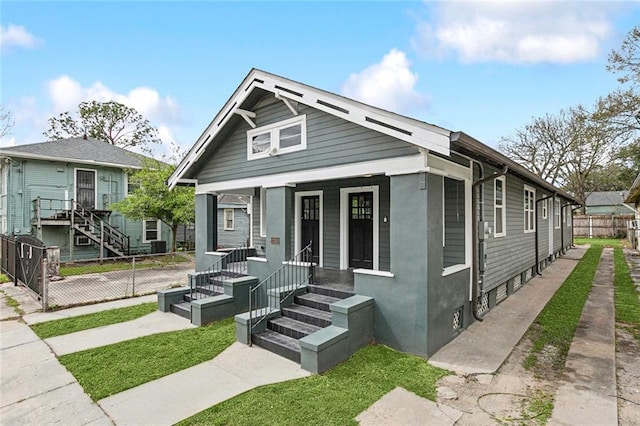 view of front of house featuring covered porch and fence