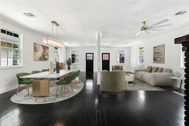 living area featuring visible vents, ceiling fan, crown molding, and hardwood / wood-style flooring