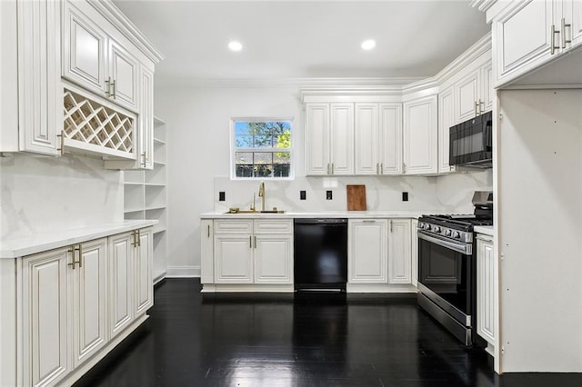 kitchen featuring dark wood finished floors, black appliances, white cabinets, and a sink