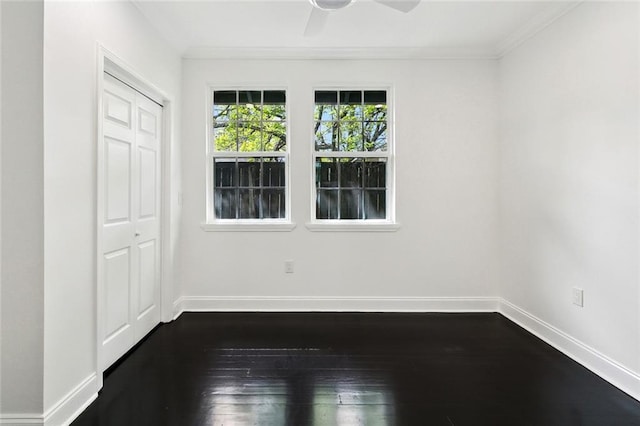 empty room with ceiling fan, baseboards, dark wood-style flooring, and ornamental molding