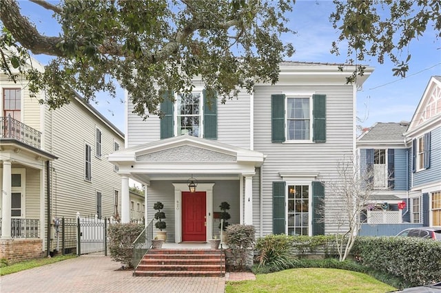 view of front of property featuring a porch and fence