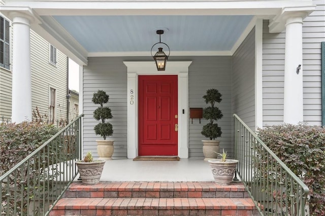 doorway to property featuring covered porch