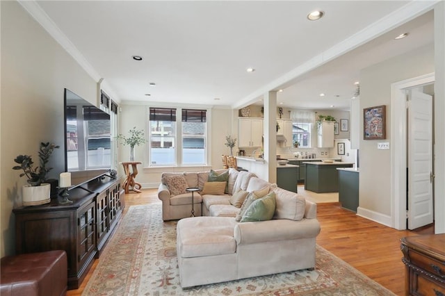 living area with recessed lighting, baseboards, light wood-style floors, and ornamental molding