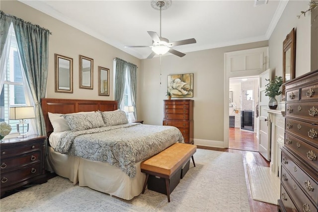 bedroom with multiple windows, wood finished floors, baseboards, and ornamental molding