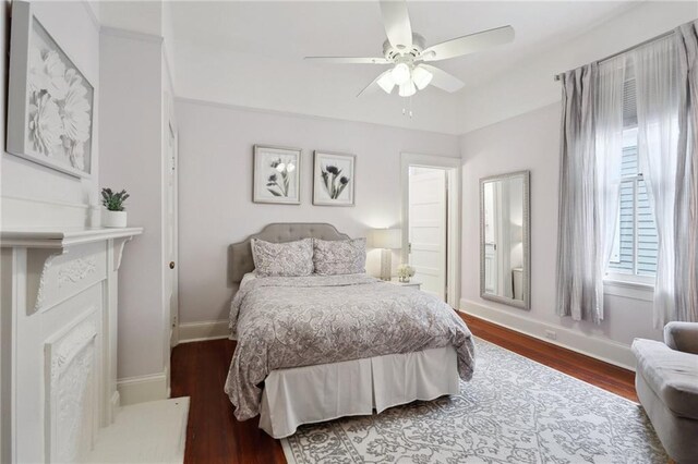 bedroom featuring a ceiling fan, wood finished floors, and baseboards