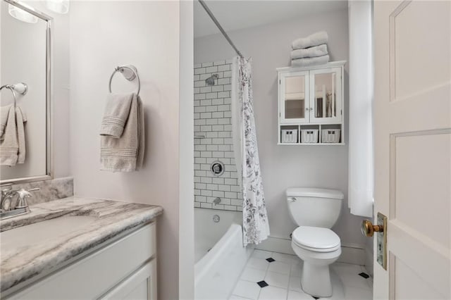 bathroom featuring vanity, baseboards, shower / bath combo, tile patterned floors, and toilet