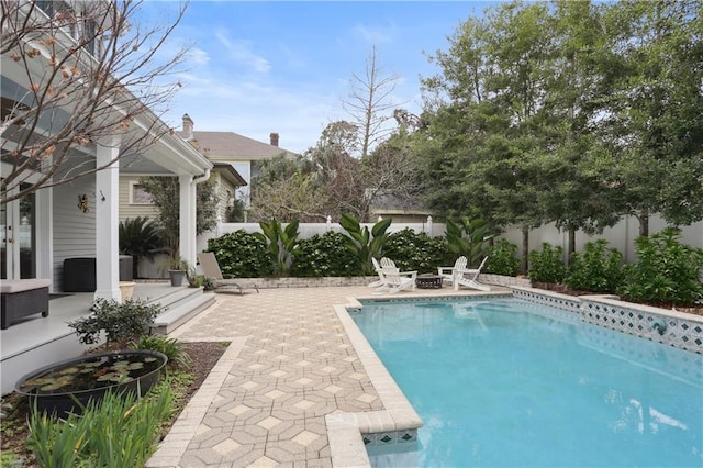 view of swimming pool with a fenced backyard, a fenced in pool, and a patio