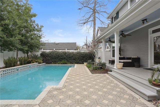 view of swimming pool with a patio, a ceiling fan, a fenced in pool, a fenced backyard, and outdoor lounge area