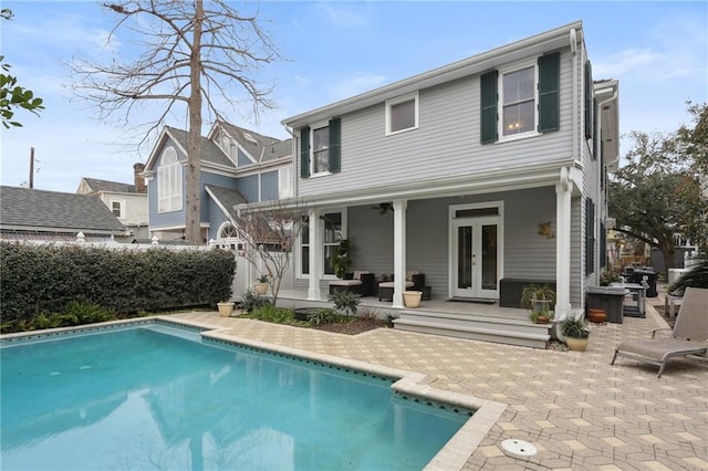 back of house with a patio, fence, french doors, and a fenced in pool